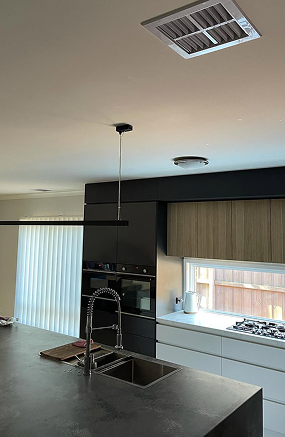 Ducted air conditioning ceiling outlet above a modern kitchen